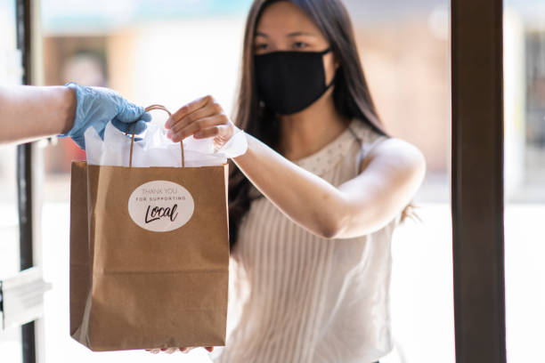 istock Young Asian woman picking up an order curbside 1243863028