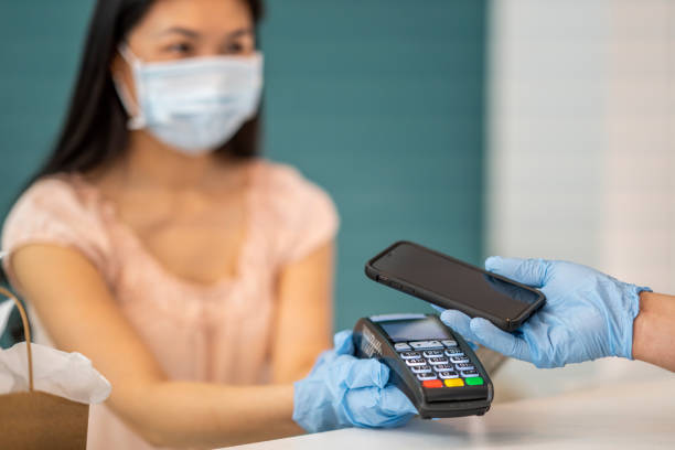 istock Business owner doing a contactless transaction at her shop 1243863033
