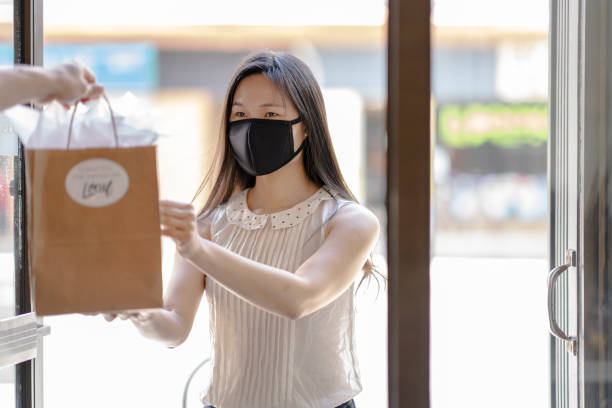 istock Young Asian woman picking up an order curbside 1243863048