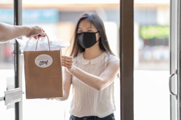 istock Young Asian woman picking up an order curbside 1243863049