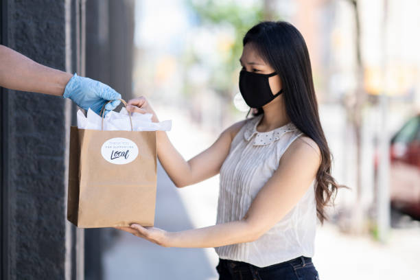 istock Young Asian woman picking up an order curbside 1243863056