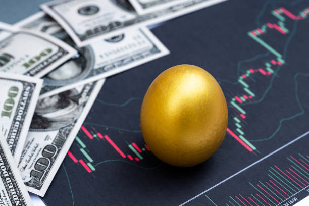 istock Golden egg and dollar bank note isolated on Bar graph background 1243869034