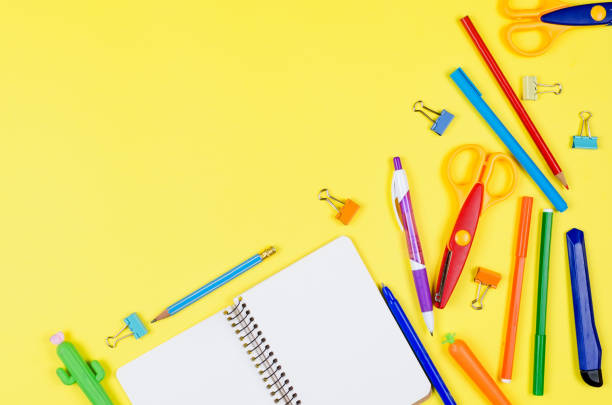 istock Colored different school supplies on yellow paper background. 1243869662
