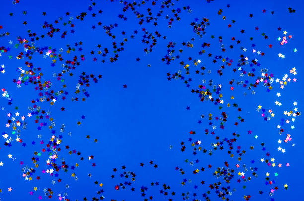 istock Shining little colorful stars on blue background. 1243869670