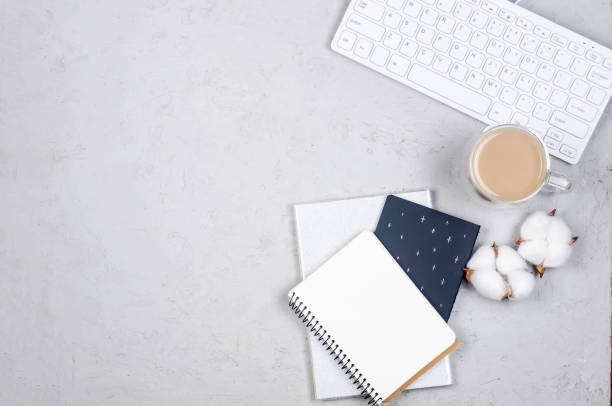 istock desktop with blank notebooks, pens, glasses and coffee 1243869674