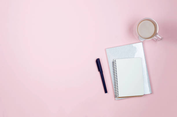 istock desktop with blank notebooks, pens, glasses and coffee 1243869685
