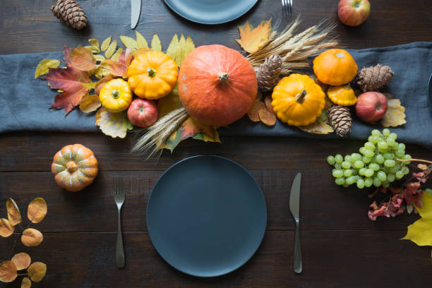 istock Autumn place setting with leaves, garland and pumpkins 1243872392