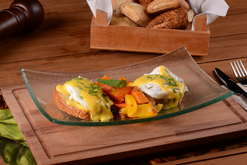 eggs benedict on the bread in the glass dish