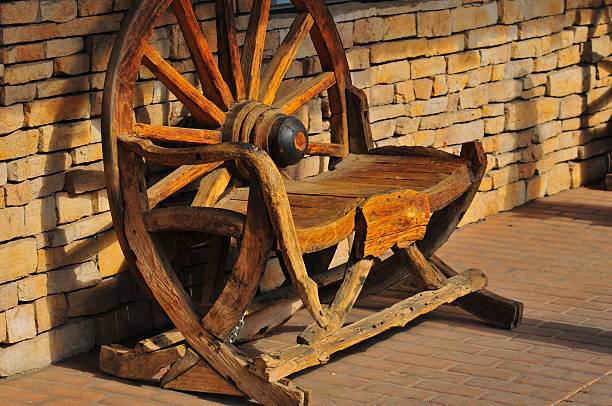 Bench A bench made of parts from a wagon. wagon wheel bench stock pictures, royalty-free photos & images