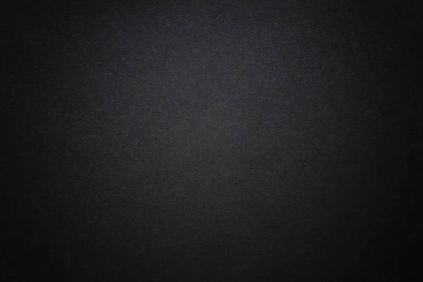 istock Black dark background with light copyspace in middle. Toned grunge retro vintage wallpaper with cardboard texture surface. Mockup design for dark arts. Blackout Tuesday concept. protest. 1243904255