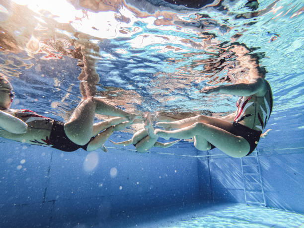 istock Underwater photo of a synchronized swimming team 1243947082