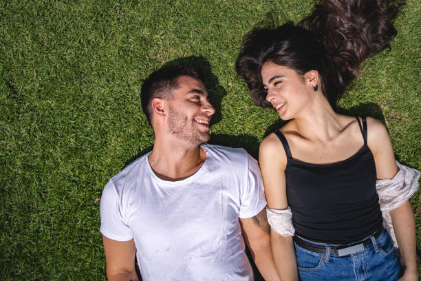 istock Latino couple relaxing on grass 1243951330