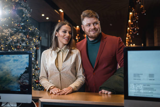 istock Handsome couple reserving a hotel room 1243951868