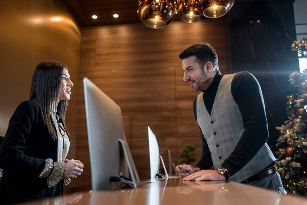 istock Macho businessman talking to the hotel receptionist 1243951876