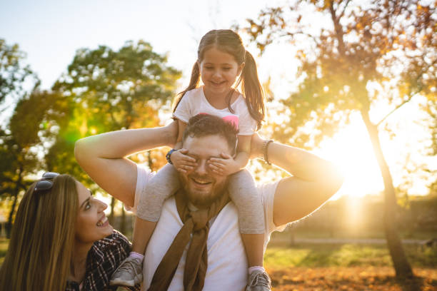 istock Girl covering her dads eyes while playing at the park 1243951892