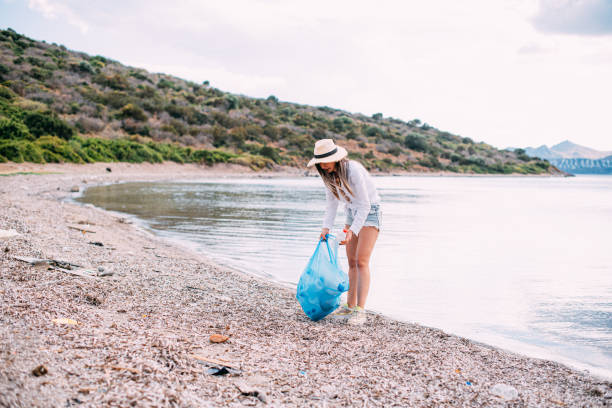 istock Woman Collecting Garbage on the Beach 1243955195