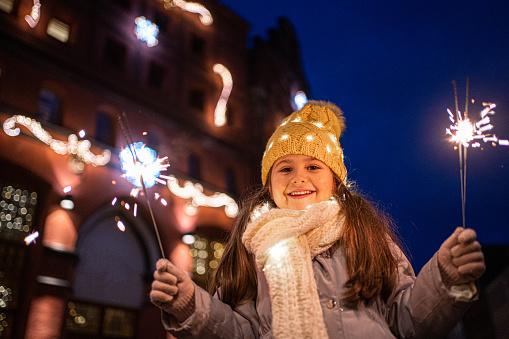 Little girl standing on a city street in Germany on New Year's Eve