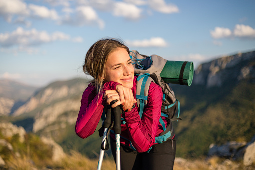 Female hiker exploring the top of a mountain