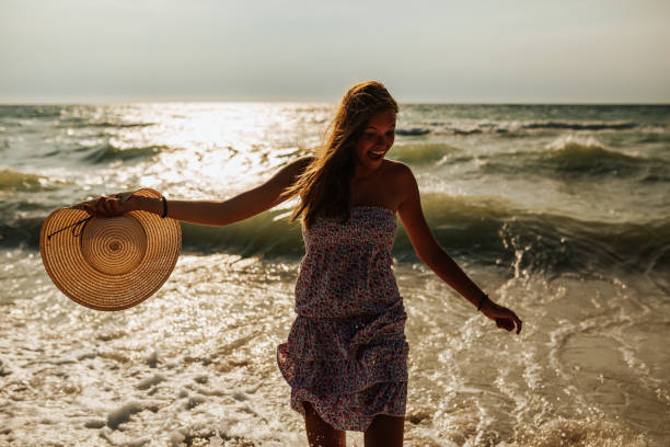 istock Beautiful young woman having fun on the beach 1243968209