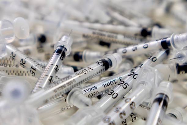 istock Used medical syringes close up 1243995202