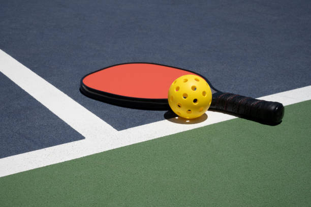 Pickleball - image of Pickleball Equipment on Court with Late Afternoon Shadows Pickleball equipment on court during a game pickleball stock pictures, royalty-free photos & images