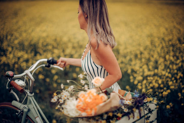 istock Woman driving bicycle in meadow 1244034549