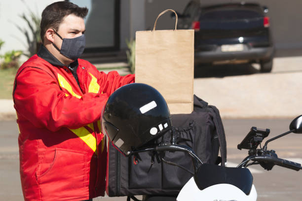 istock Man working as motoboy. Delivering with a motorcycle. 1244070394