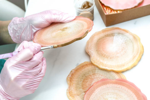 istock Creativity and craft. A young girl creates coasters from resin. Gift wrapping. Decorative packaging. Idea for business. Remote work, work at home. Art coasters. 1244090155