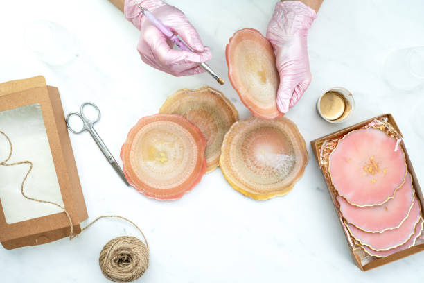 istock Creativity and craft. A young girl creates coasters from resin. Gift wrapping. Decorative packaging. Idea for business. Remote work, work at home. Art coasters. 1244090170
