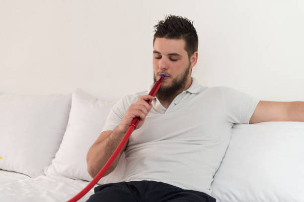 istock Man Smoking Shisha In The Arabic Cafe 1244090344
