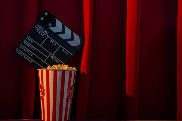 istock mobile phone with empty white bright screen with popcorn bucket on the red sofa. Concept of streaming TV on internet phone. 1244115501