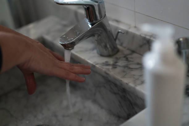 istock Woman washing her hands at the bathroom 1244131700