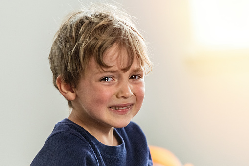 Caucasian Child boy crying looking at the camera