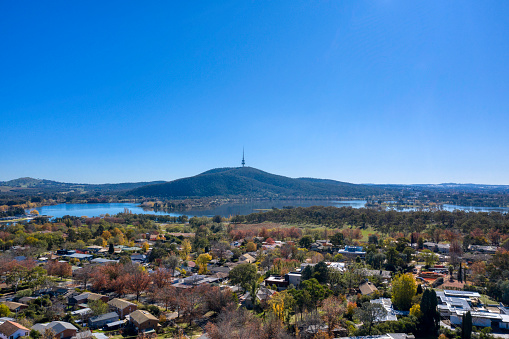 Aerial shot from the suburb Yarralumla on a sunny day looking towards lake Burley Griffin and Telstra tower.