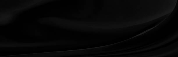 istock Black gray satin dark fabric texture luxurious shiny that is abstract silk cloth panorama background with patterns soft waves blur beautiful. 1244178816