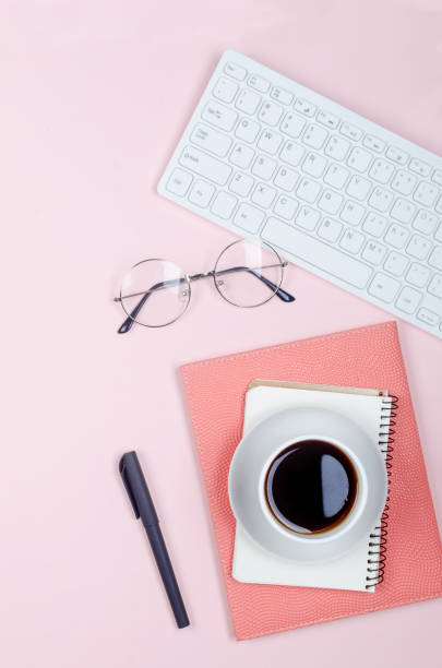 istock desktop with blank notebooks, pens, glasses and coffee 1244201058
