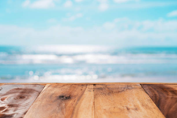 istock Selective focus of old wood table with blue sky background for display your product. 1244221336