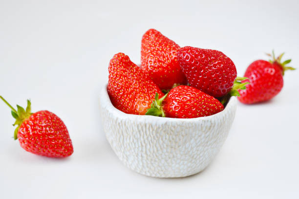 istock strawberries in a bowl isolated on white 1244257233