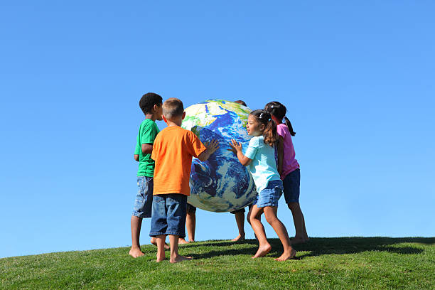 istock Group of multi-ethnic kids holding large earth ball 124428296
