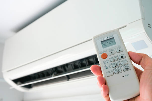 istock Man's hand using remote control open The air conditioner is cooled to 25 degrees Celsius in his bedroom. Health concepts and energy savings 1244285761