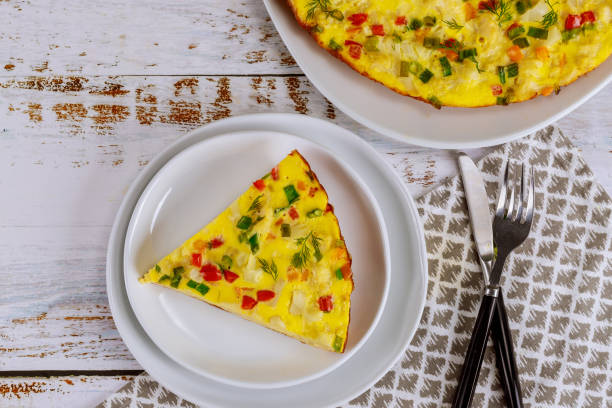 istock Colorful scrambled eggs with vegetables on white plate. 1244294688