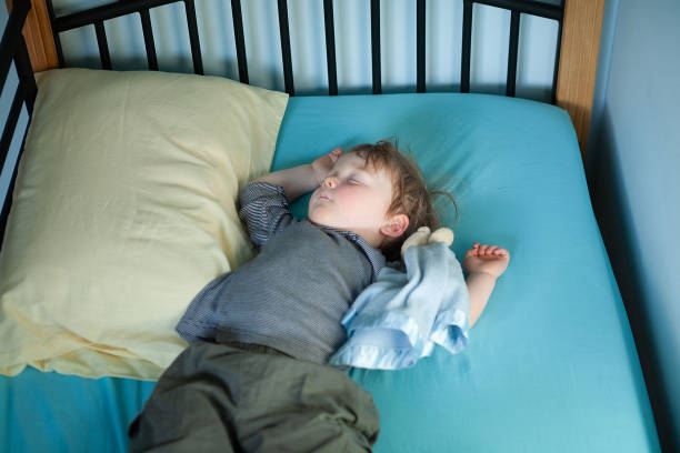 istock Little Boy asleep on his bed 1244326755