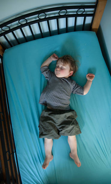 istock Little Boy asleep on his bed 1244327827