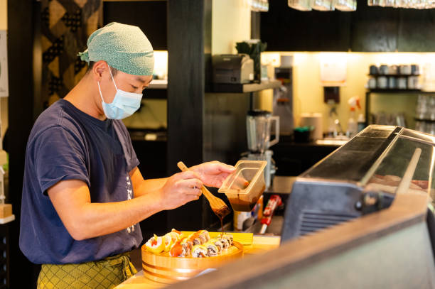 istock Japanese sushi chef wearing a mask for Covid-19 1244330470