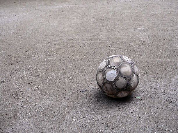 very old football ball on the playground