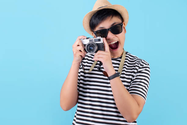 istock Happy tourists taking pictures on a blue background in the studio. 1244344737