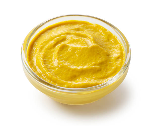 istock Mustard sauce in a glass bowl set against a white background 1244351353