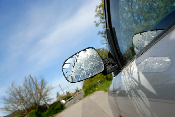 Broken Side-View Mirror Broken side-view mirror of a parked car. broken side view mirror stock pictures, royalty-free photos & images