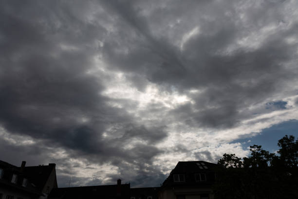 View to blue sky and clouds over the roofs