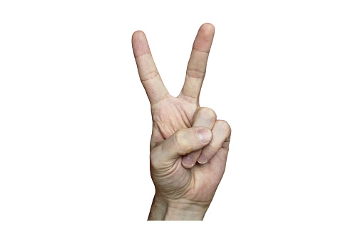 Male hand with fair skin shows a gesture, hand on a white isolation background. Victory sign. Stock photo for web and print.
